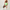 Woman wearing a black sports bra and green shorts with a white background