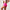 Woman wearing pink athletic shorts and top on a plain background