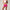 Woman wearing a pink sports bra and shorts on a plain background